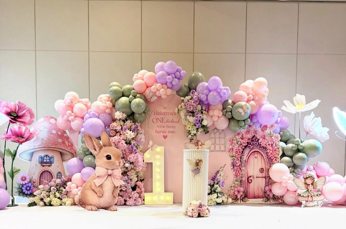 Enchanted pastel fairytale birthday celebration with floral plinths and personalized signage