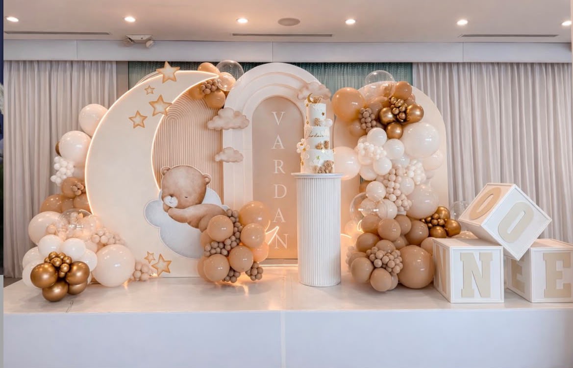 Minimalist bohemian neutral-toned birthday decor with pampas grass and rattan details