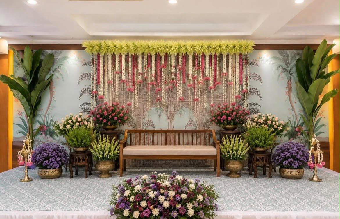 Intimate engagement ceremony seating arrangement with artisanal floral chandeliers