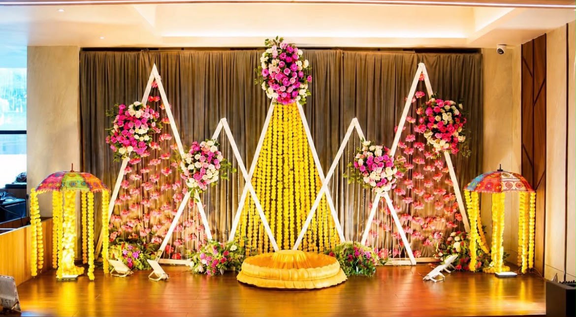 Sunny yellow and marigold floral decor setup for haldi celebrations