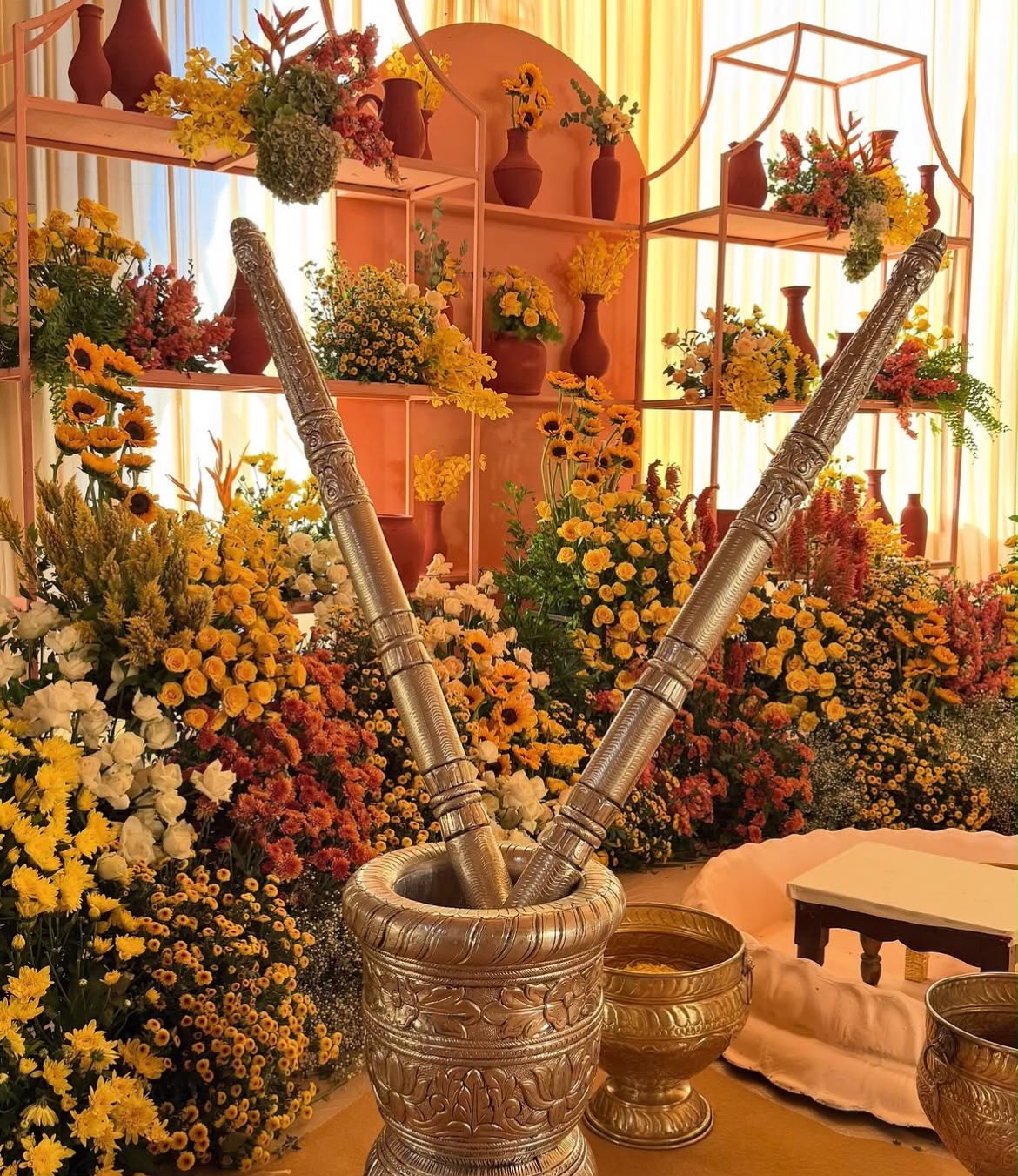 Traditional brass urli and flower petal baths for bride and groom haldi