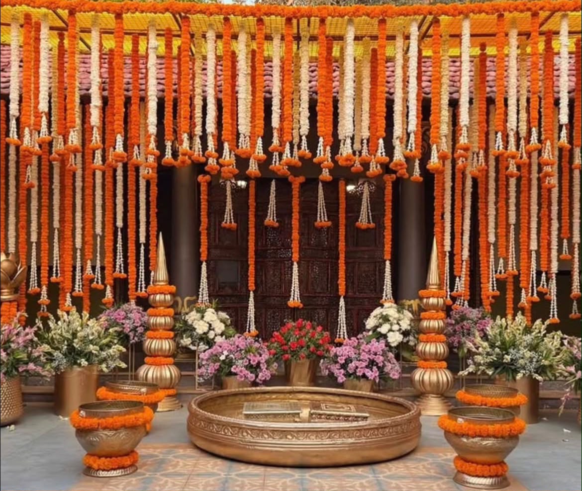 Playful haldi stage styling with bright pink and yellow jaali screens