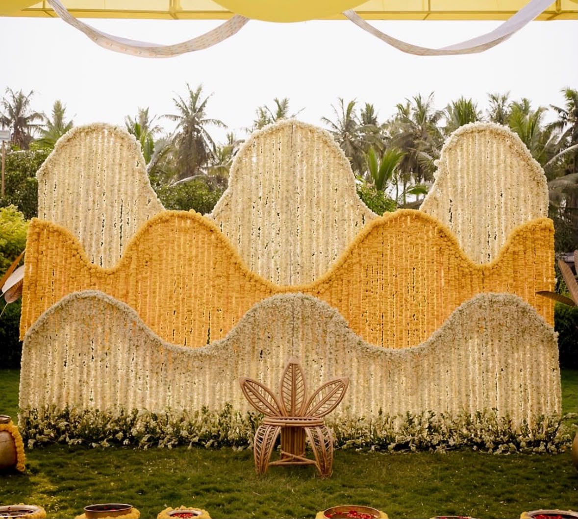 Chic Bohemian haldi ceremony lounge with botanical arrangements and brass pots