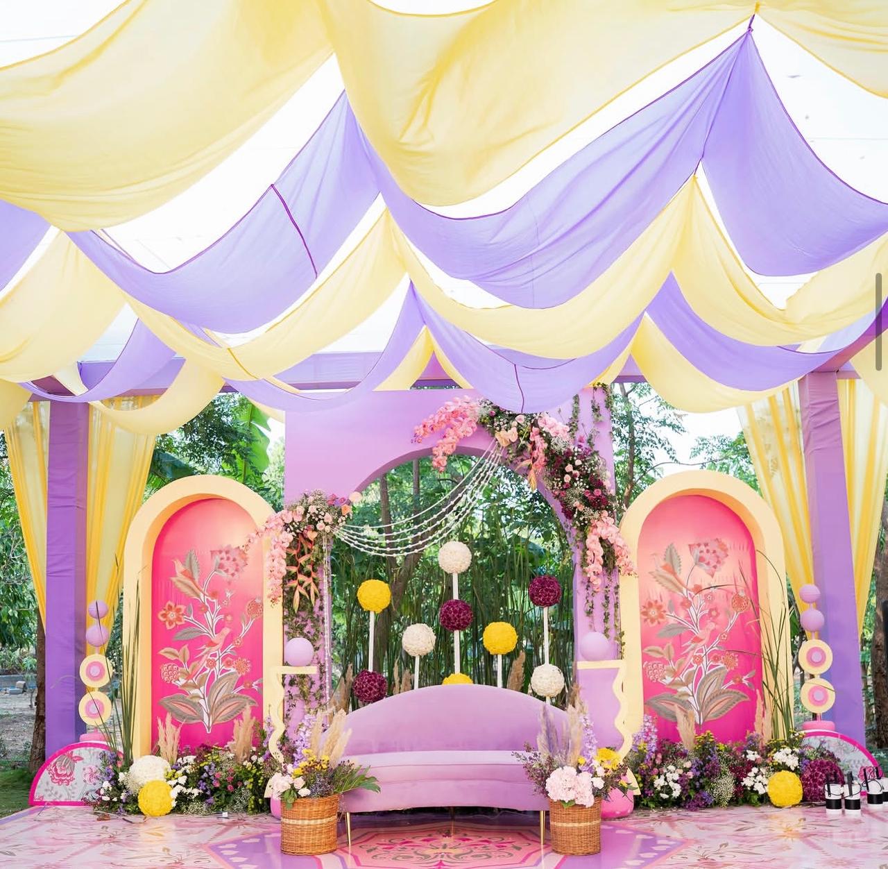 Bespoke floral pergola adorned with marigolds and hanging tassels for haldi