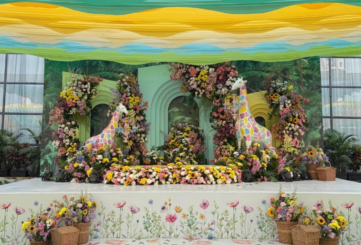 Artisanal bridal haldi setting with fresh blooms and embroidered bolster cushions