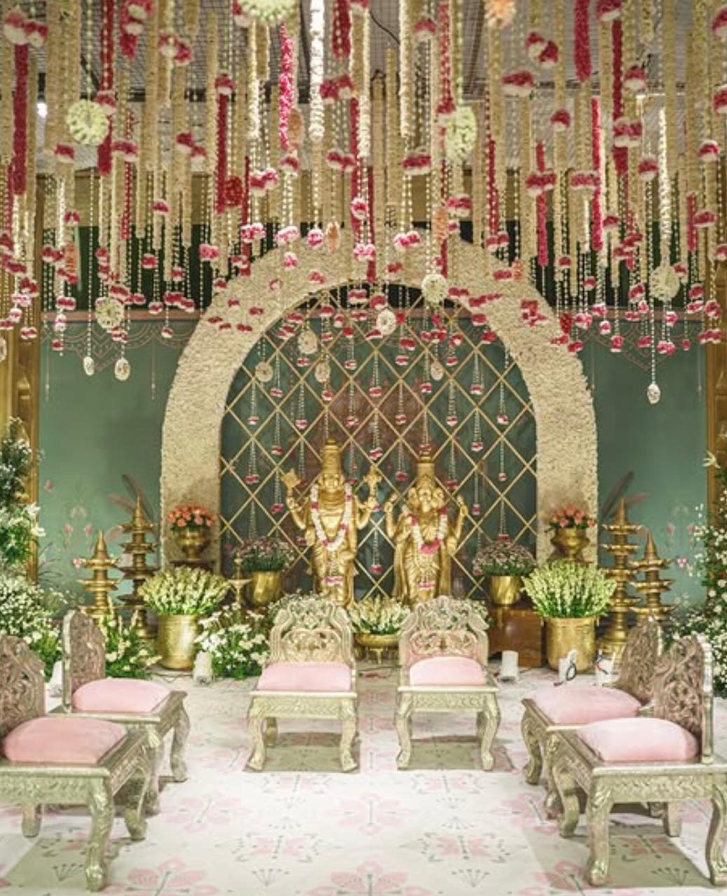 Vibrant lotus motif home backdrop with hanging marigolds and festive floor mandalas