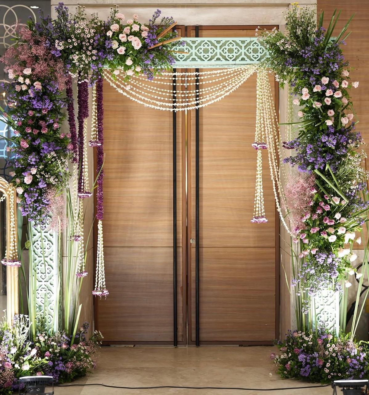 Cozy drawing room celebration decor with draped fabric backdrops and fairy lights