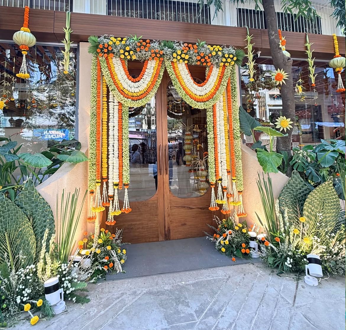 Traditional home entrance archway with fragrant jasmine drapes and yellow marigold accents
