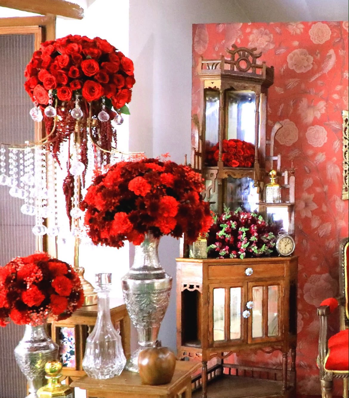 Elegant home entryway floral rangoli with lit clay diyas and brass lamps