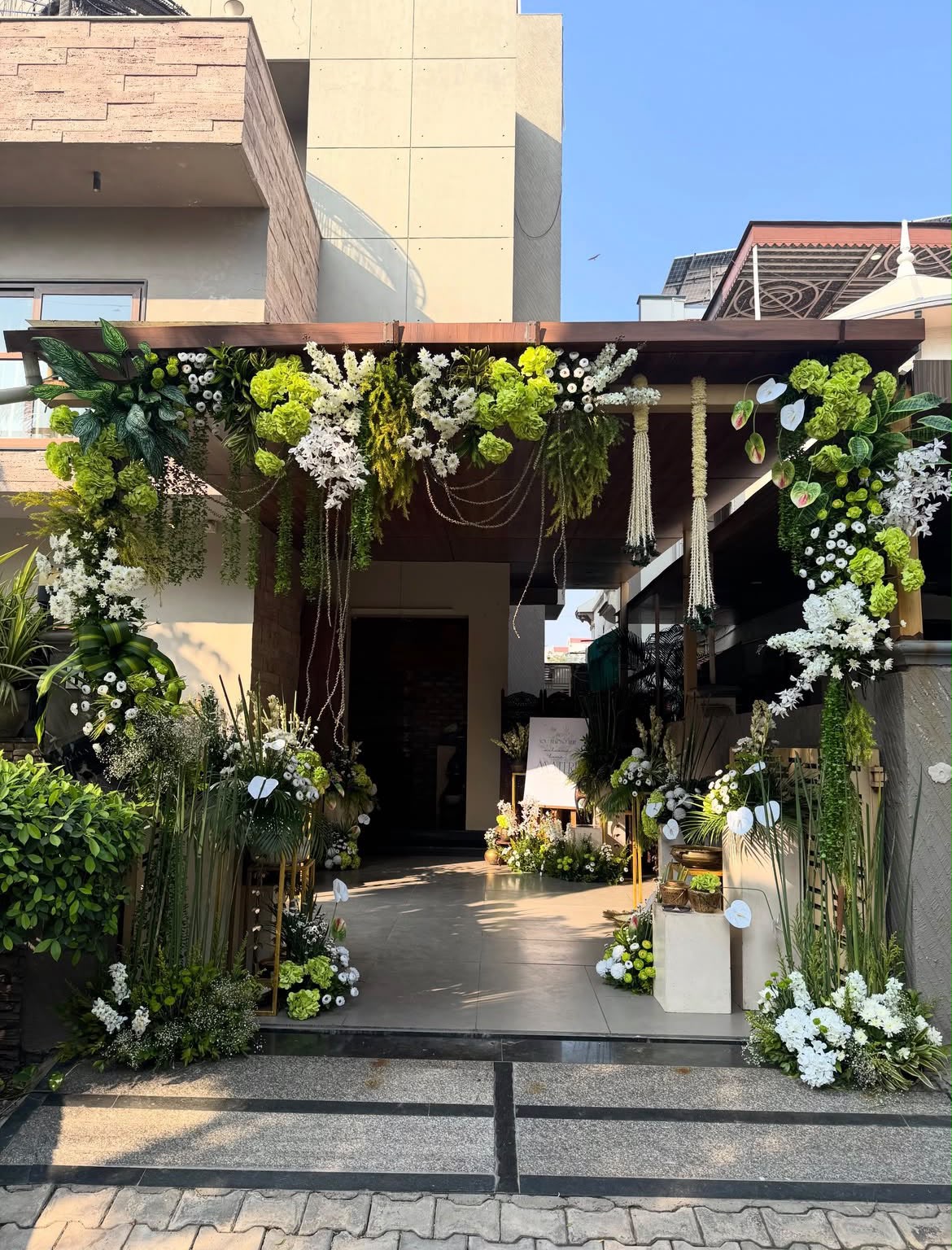Intimate home ceremony seating setup with colorful silk floor cushions and low wooden tables