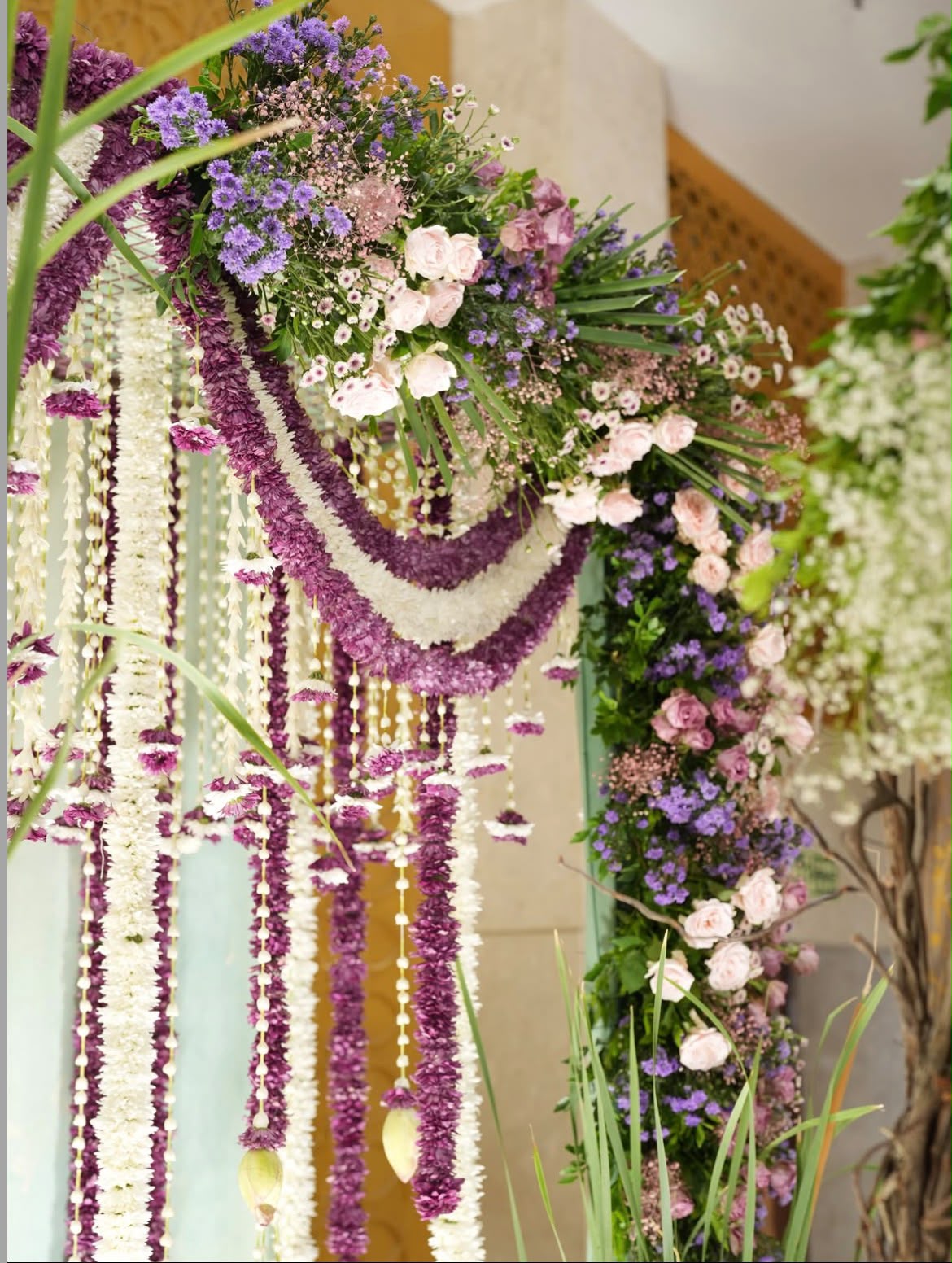Indoor house celebration backdrop with soft chiffon drapes and floral wreath centerpiece