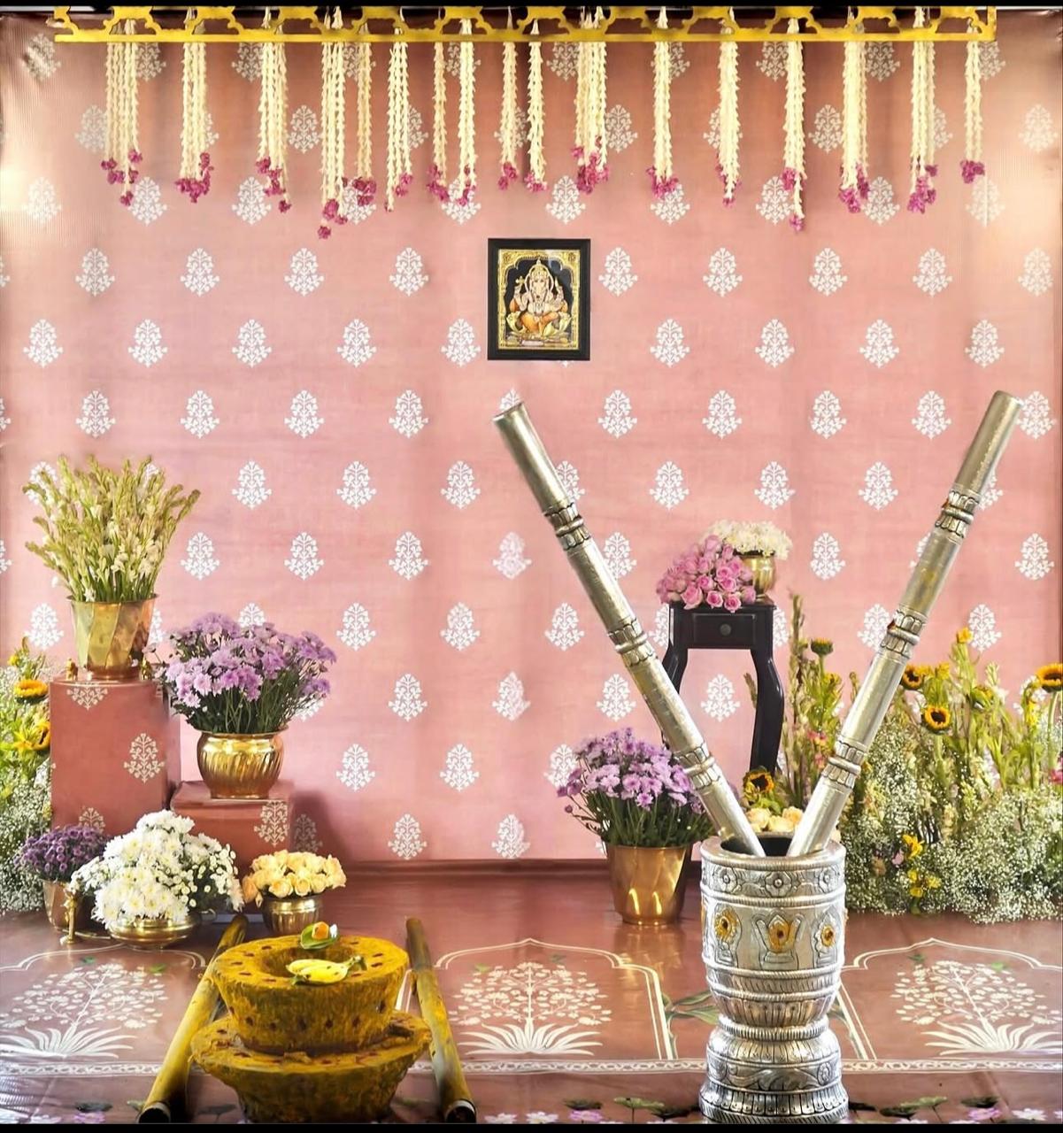 Auspicious home gathering altar with holy brass deepams and vibrant marigold hangings