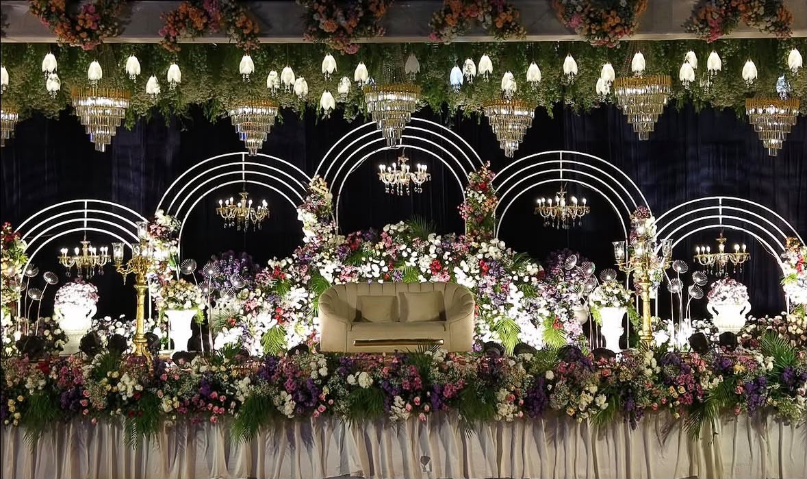 The Utsav House grand wedding reception stage with architectural arches and majestic lighting