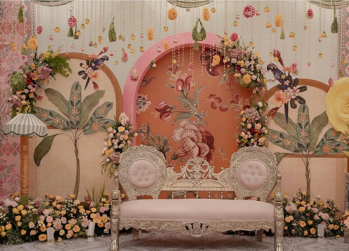 Stunning reception walkway entrance with dramatic floral archways and warm candle pillars