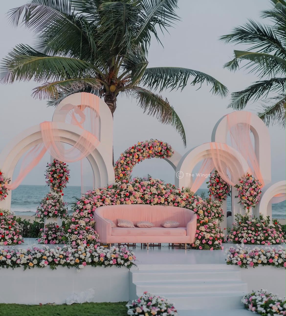 Grand floral stage backdrop designed for wedding reception celebrations and family portraits
