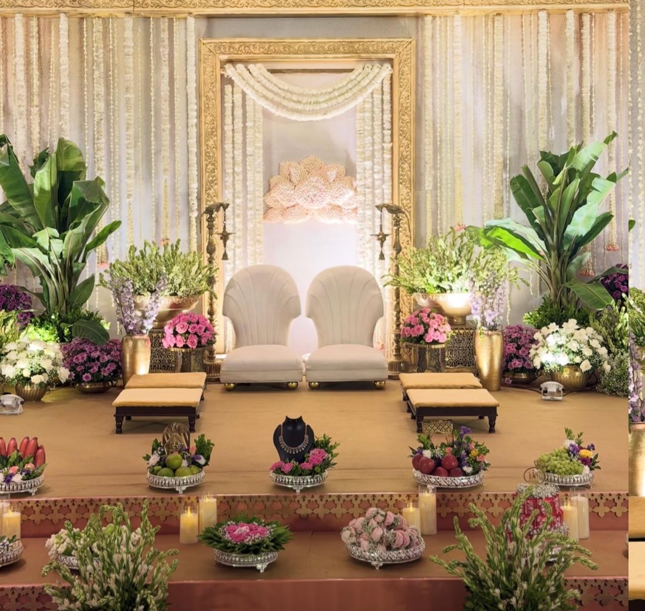 Royal wedding reception stage production with imported florals and artisanal stage framing