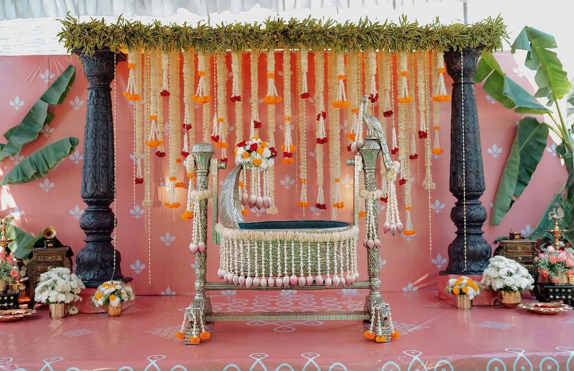 Golden scalloped arch stage backdrop with fresh rose and jasmine flower hangings