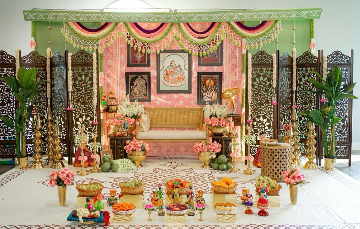 Traditional stage decor with banana tree stems, marigold curtain, and bronze temple deepams