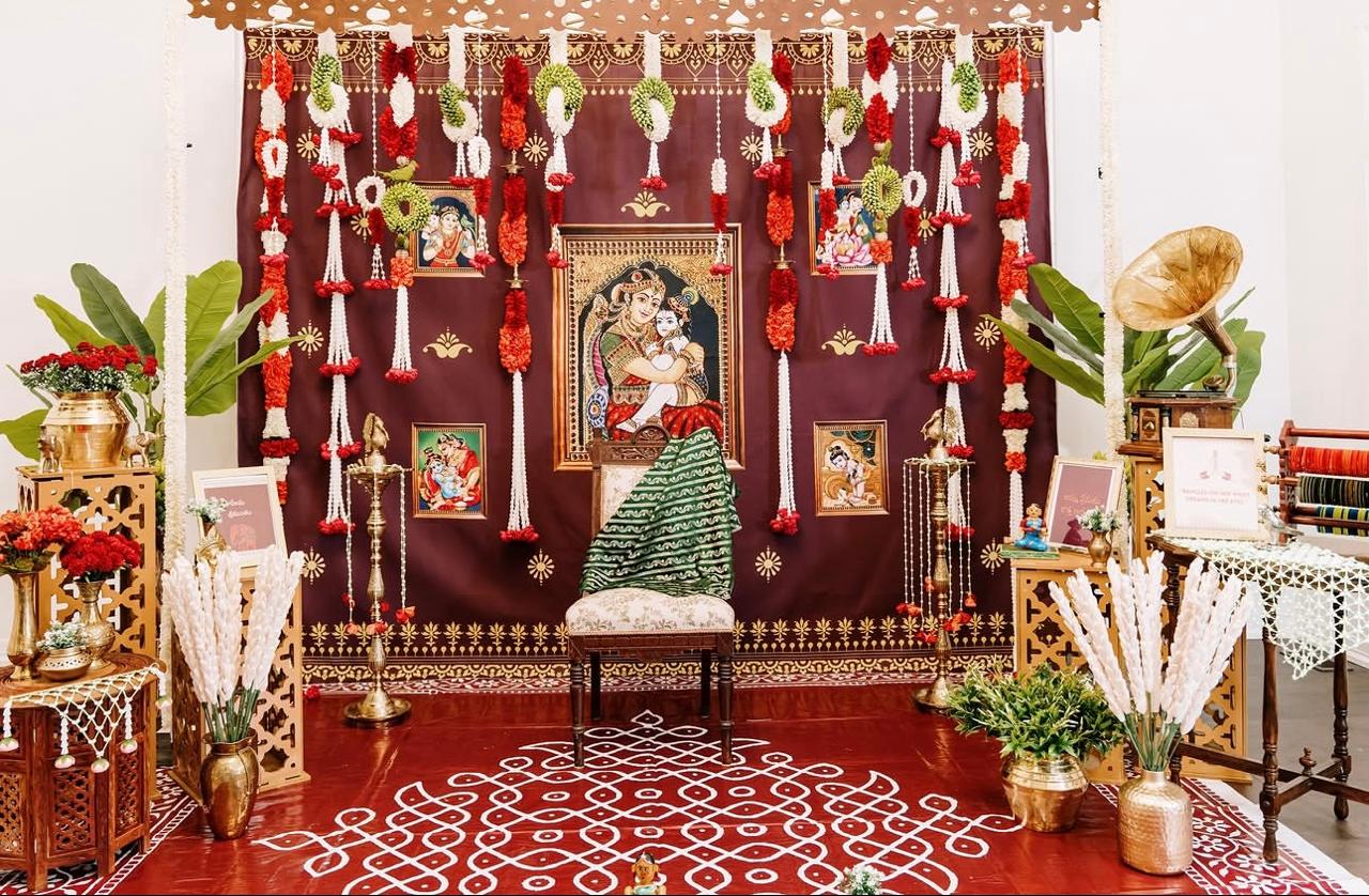 Heritage entryway gateway adorned with mango leaves, marigold strings, and traditional kolam
