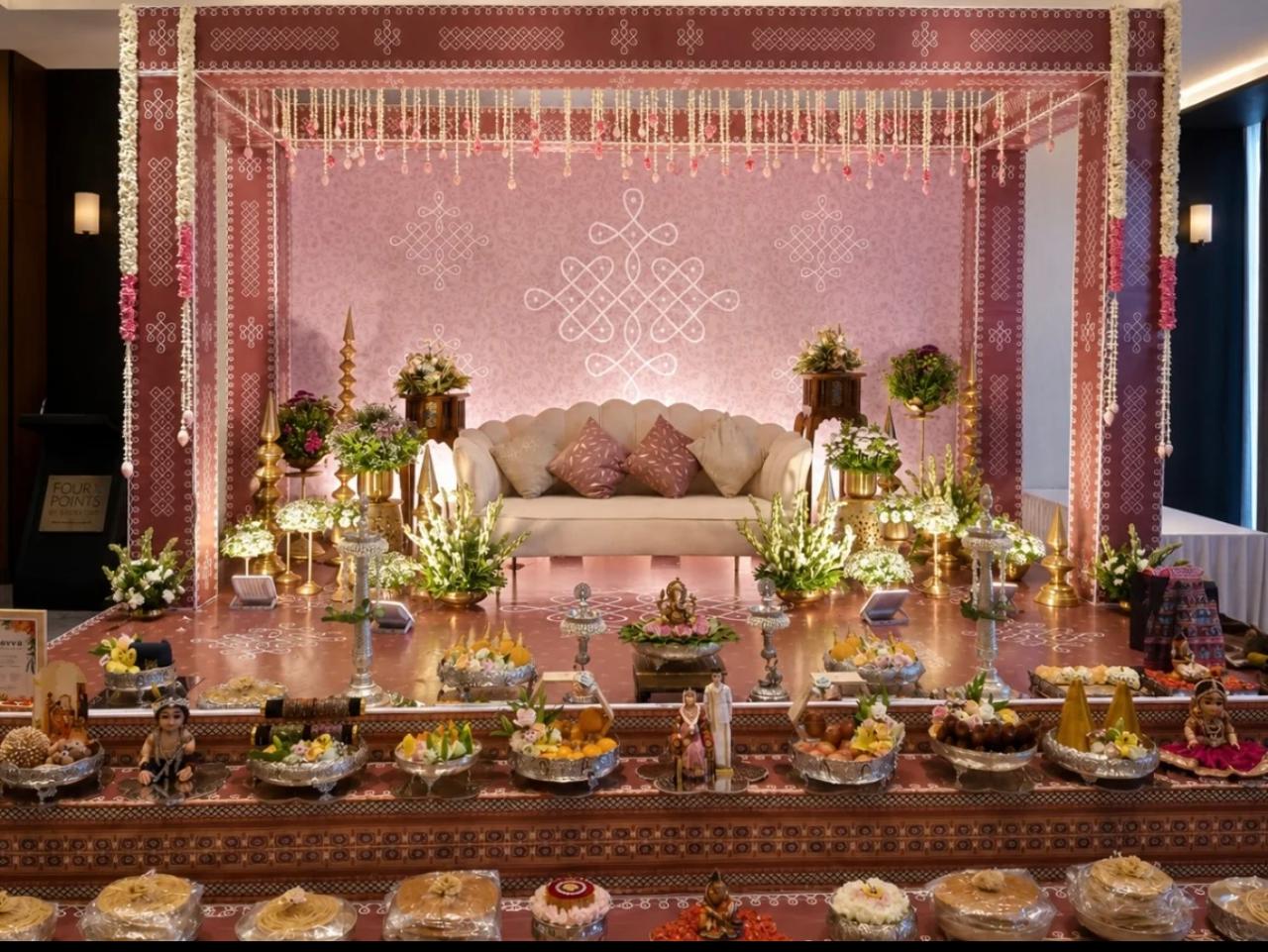 Grand festive floral canopy with cascading white garlands and terracotta diya lamps