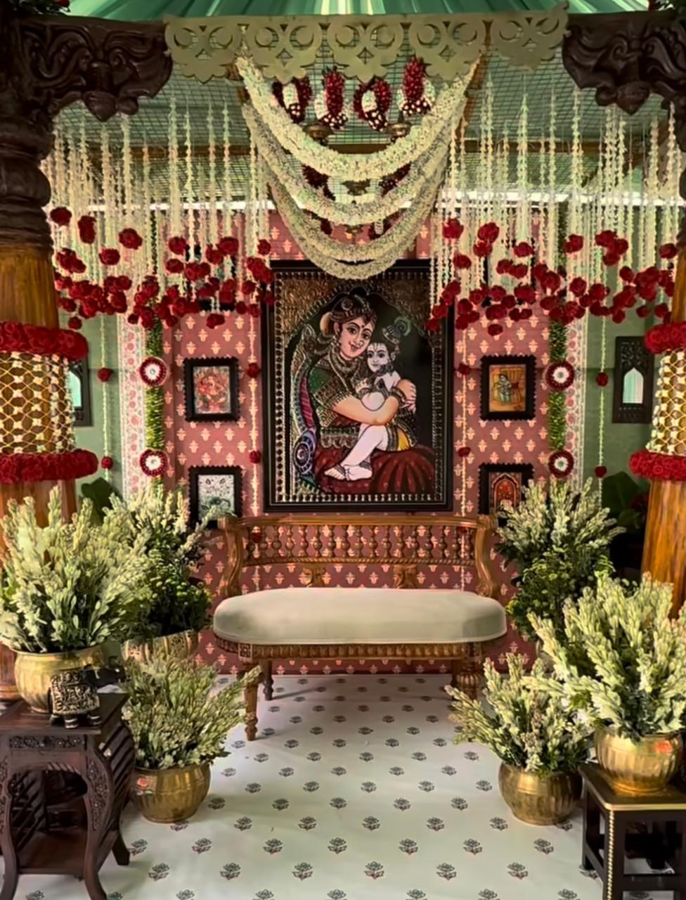 Classical music and cultural celebration stage adorned with traditional floral hangings