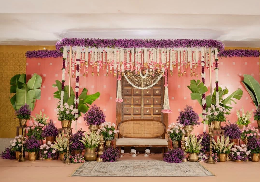 Festive house entrance decorated with auspicious toranam and brass water urlis with floating petals