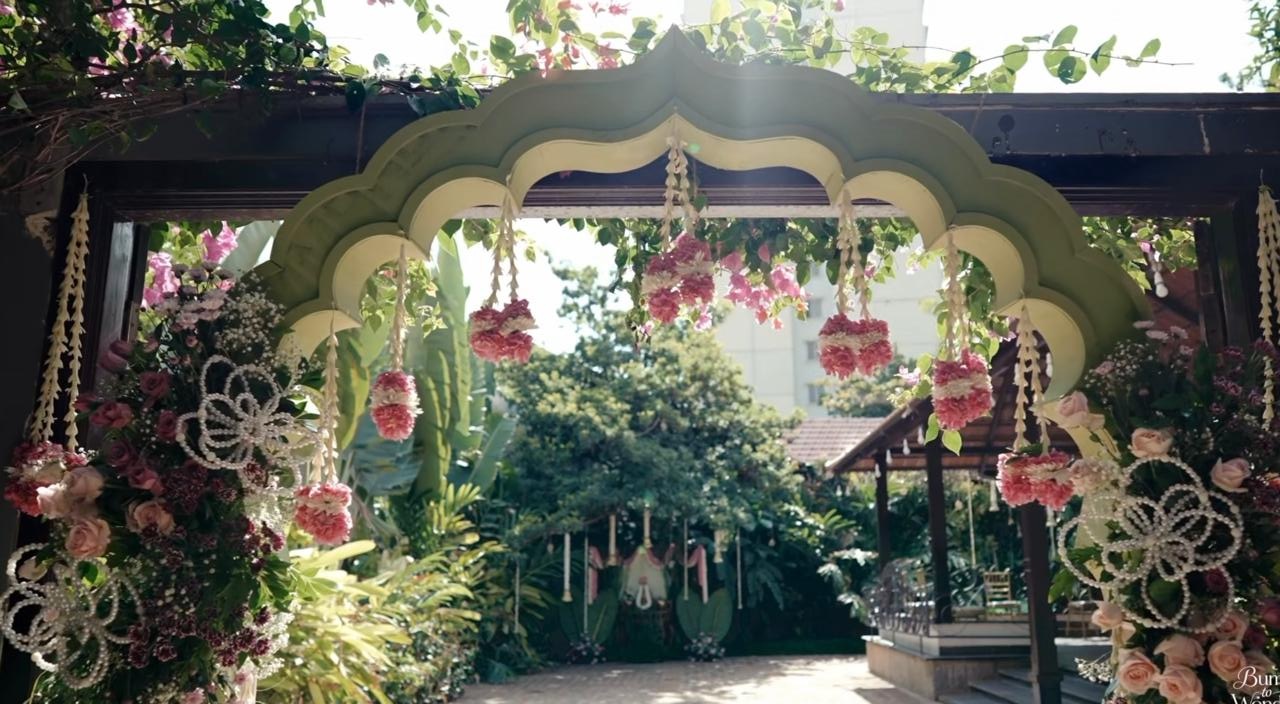 Garden entrance arch with hanging pink and white flowers